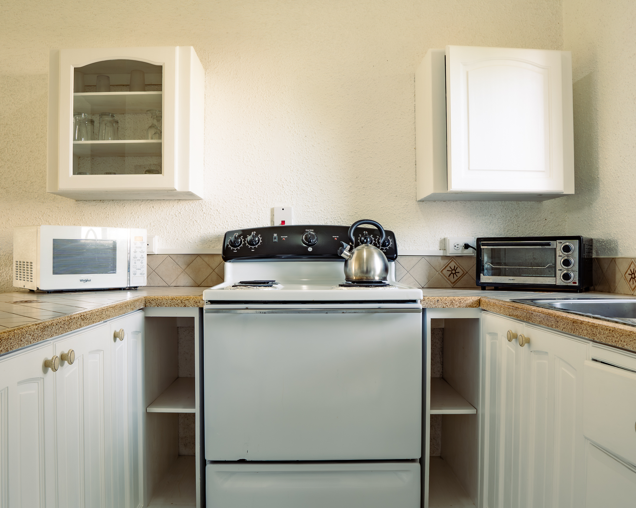 Self-catering kitchen at Plum Tree Club with a full oven, microwave and toaster oven