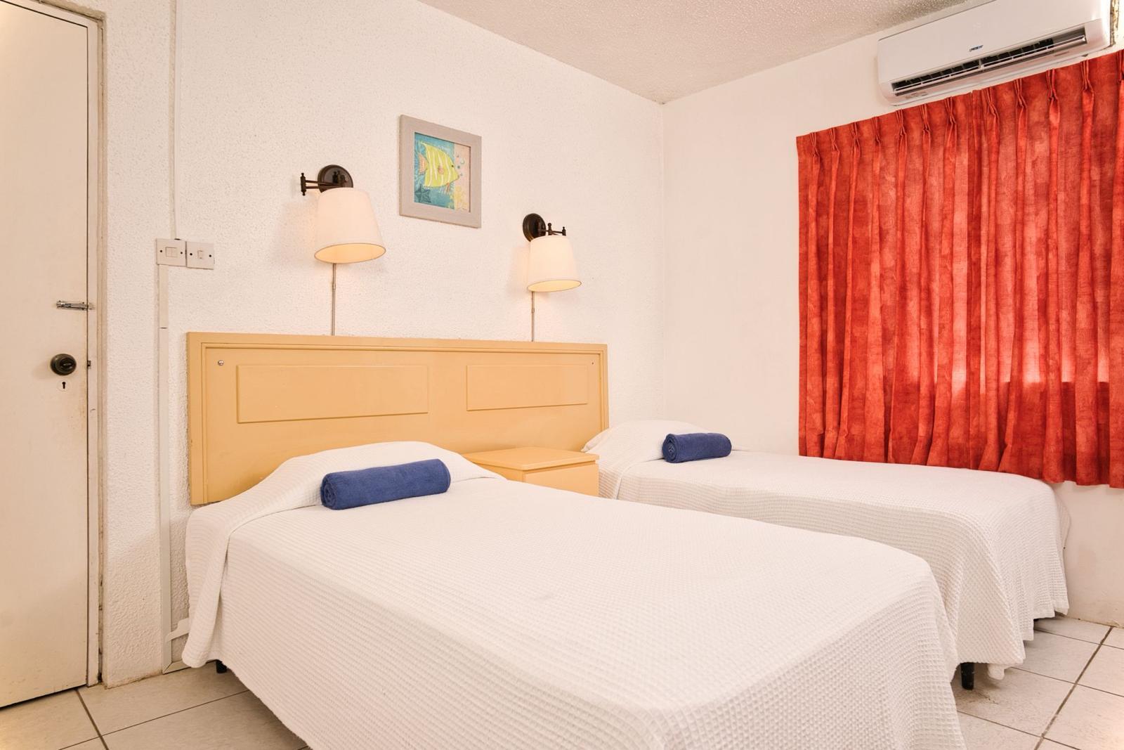 Second bedroom of a two bedroom apartment at Plum Tree Club with two single beds